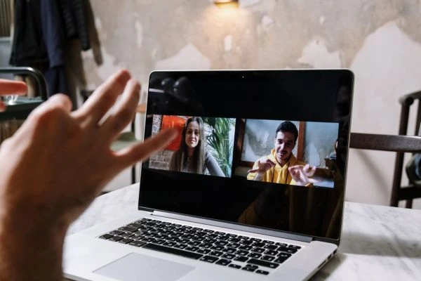 Photo of three people having a video call